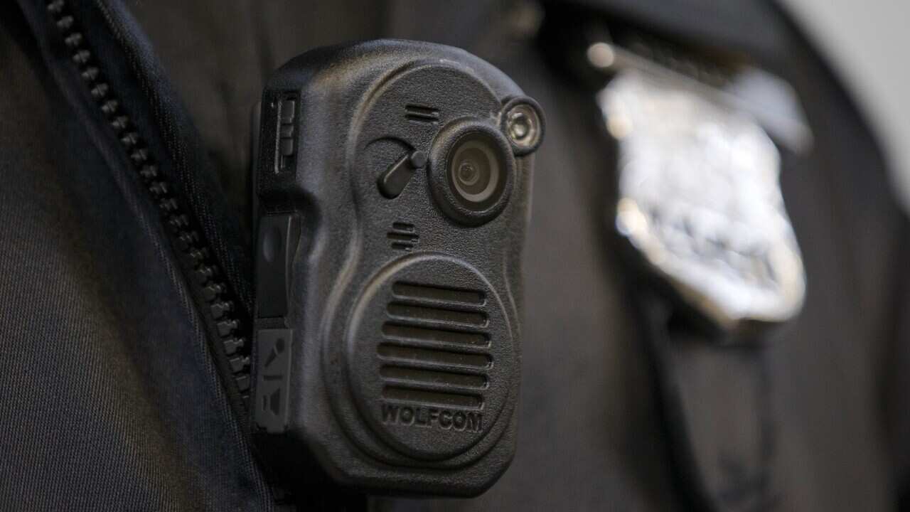 A Los Angeles Police officer demonstrating an on-body camera. (AAP)