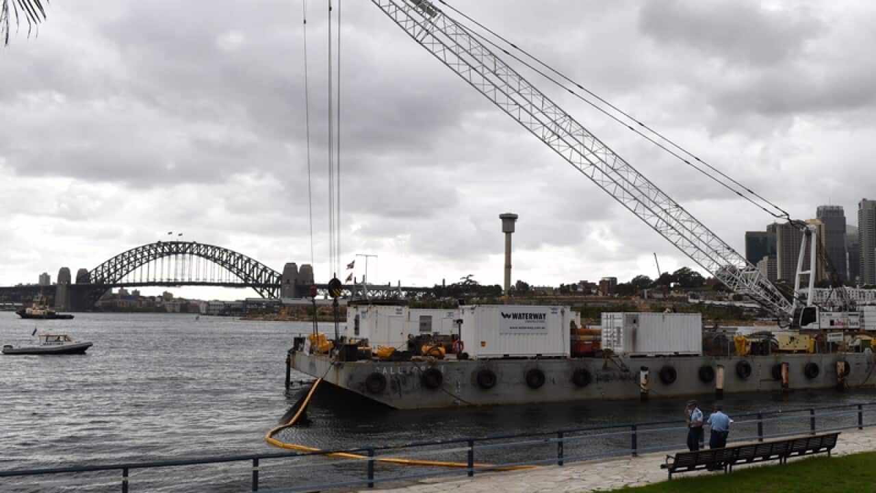 The barge and crane at Balmain East where a young man died swimming.