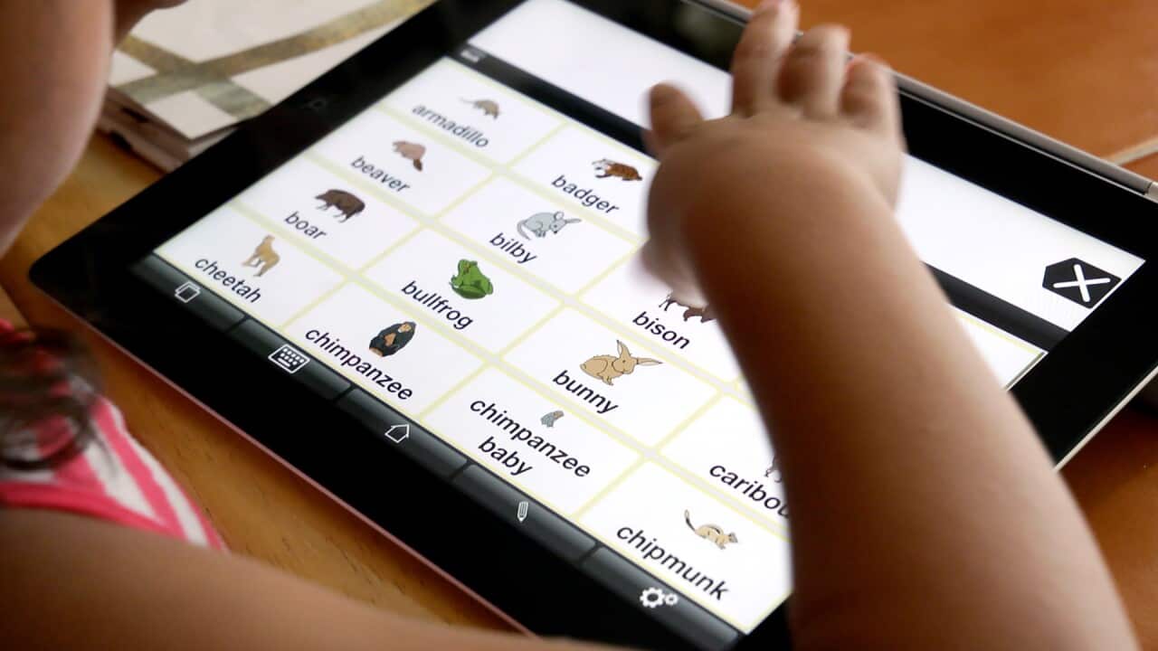 A supplied 2012 photo of a child called Vanessa who is autistic using a Proloquo2Go made by AssistiveWare. (AAP Image/AssitiveWare)