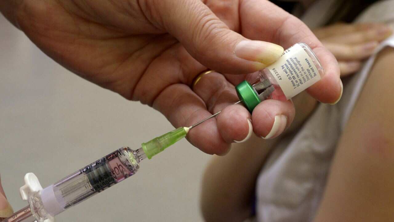 A teenager having a measles vaccination