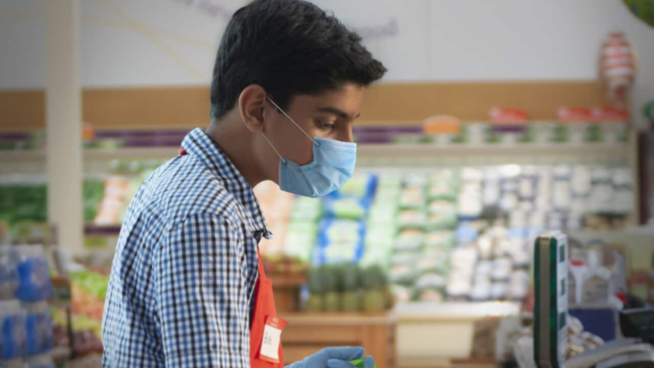 teenager working at supermarket