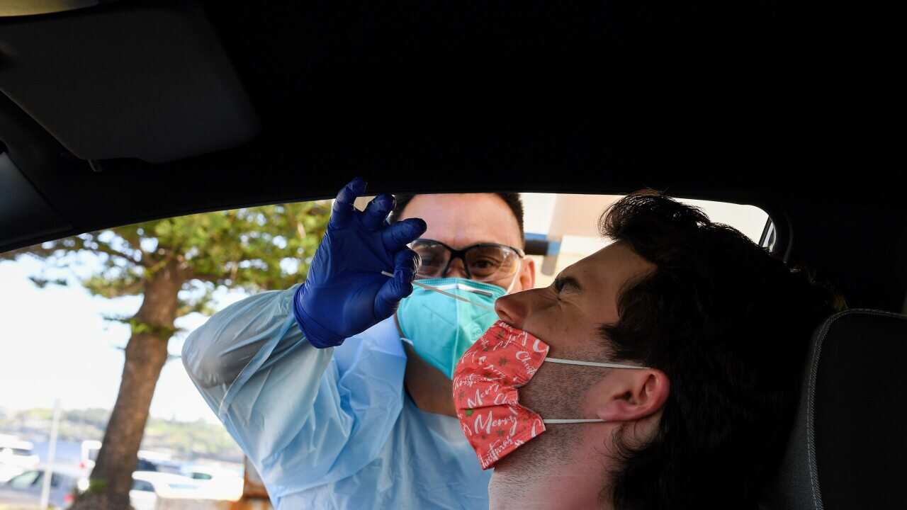 Angus Horton receives a COVID-19 test at the St Vincents Hospital drive-through testing clinic at Bondi Beach in Sydney, Wednesday, December 15, 2021. NSW will open up to the unvaccinated just as COVID-19 cases start to spiral, and the highly transmissibl