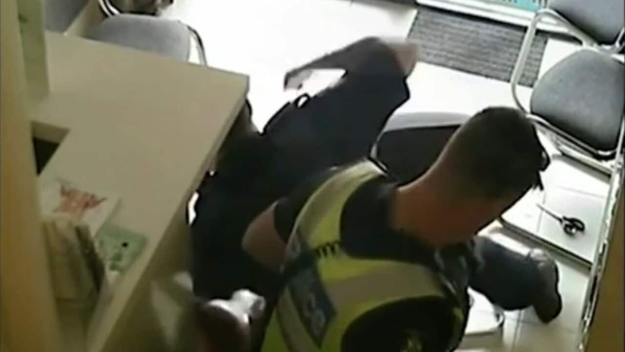 A Sudanese man is punched by a Victoria Police officer.
