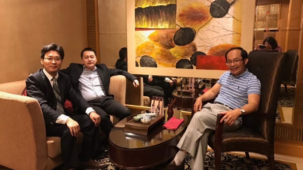 Dr Chongyi Feng (R) with two legal representatives, who he fears will be persecuted in China.
