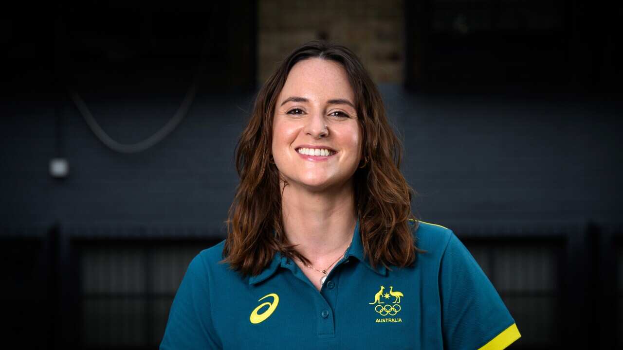 A woman in a green and yellow polo shirt