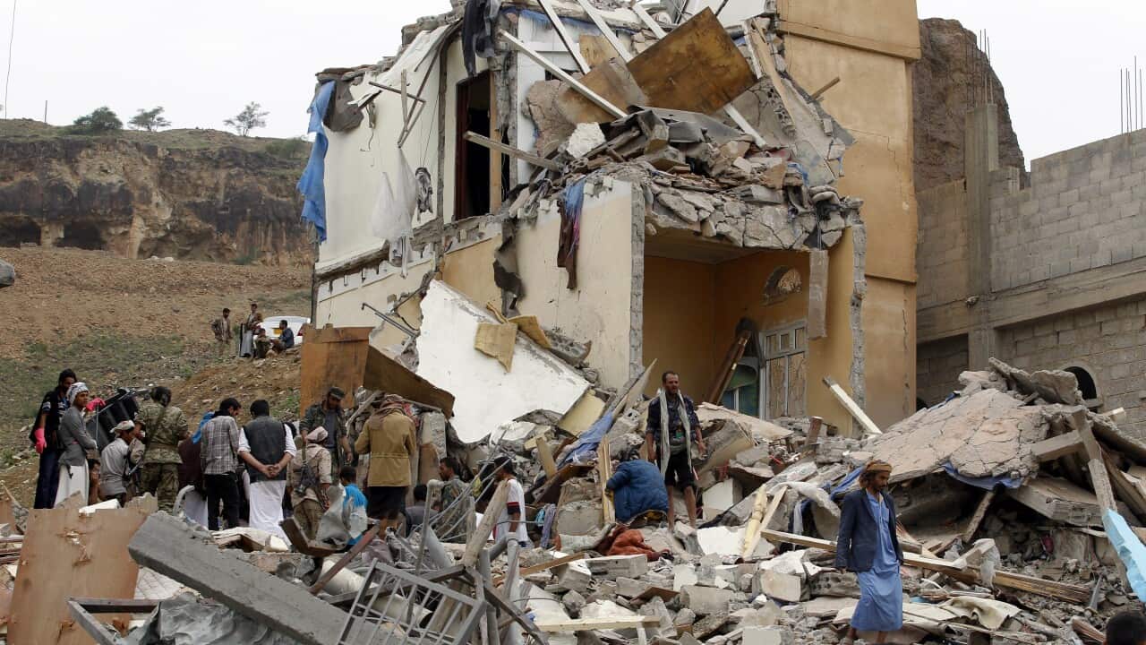 People inspect a building allegedly hit by a Saudi-led airstrike in Sanaa, Yemen.