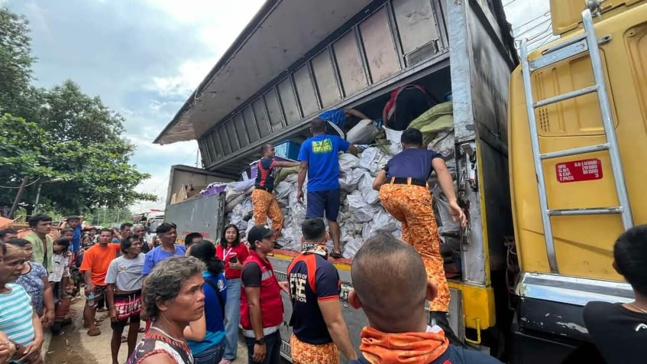 Personnel from the Bureau of Fire Protection (BFP), together with volunteer residents, unload family tents for the tent city being set up at SM Care Village in Barangay Pulangbato, Bogo City, Cebu on Friday (Oct. 3, 2025), to provide temporary shelters for those displaced by the Sept. 30 magnitude 6.9 earthquake.