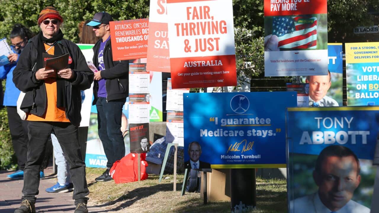 Election volunteers for political parties outside a polling booth