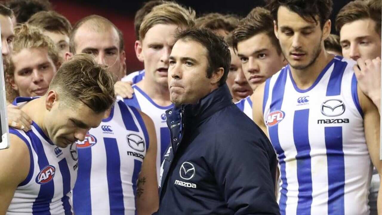North Melbourne coach Brad Scott and his players