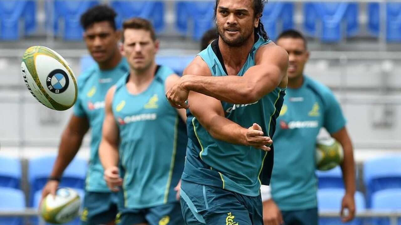 Karmichael Hunt passes the ball during a team training.