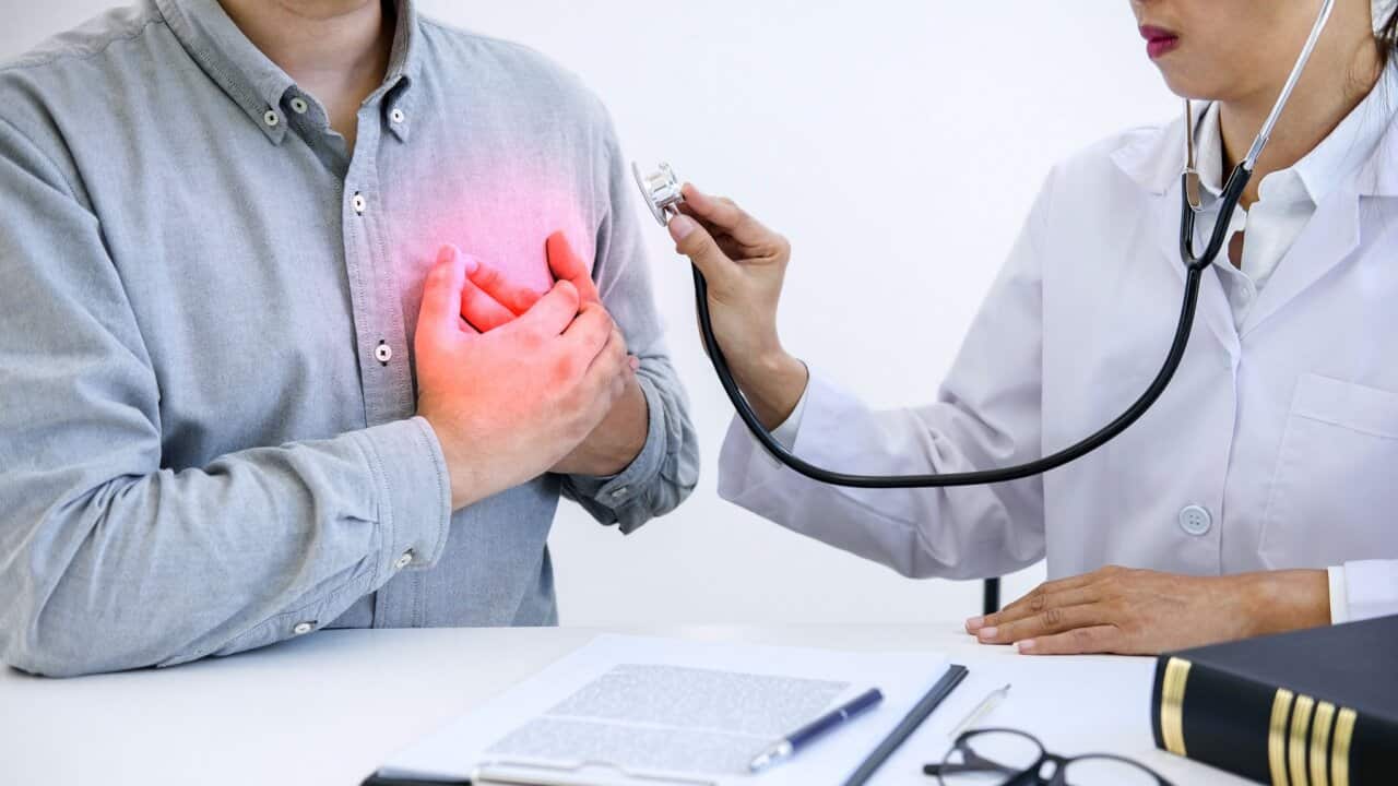 Midsection Of Doctor Examining Patient Chest In Hospital
