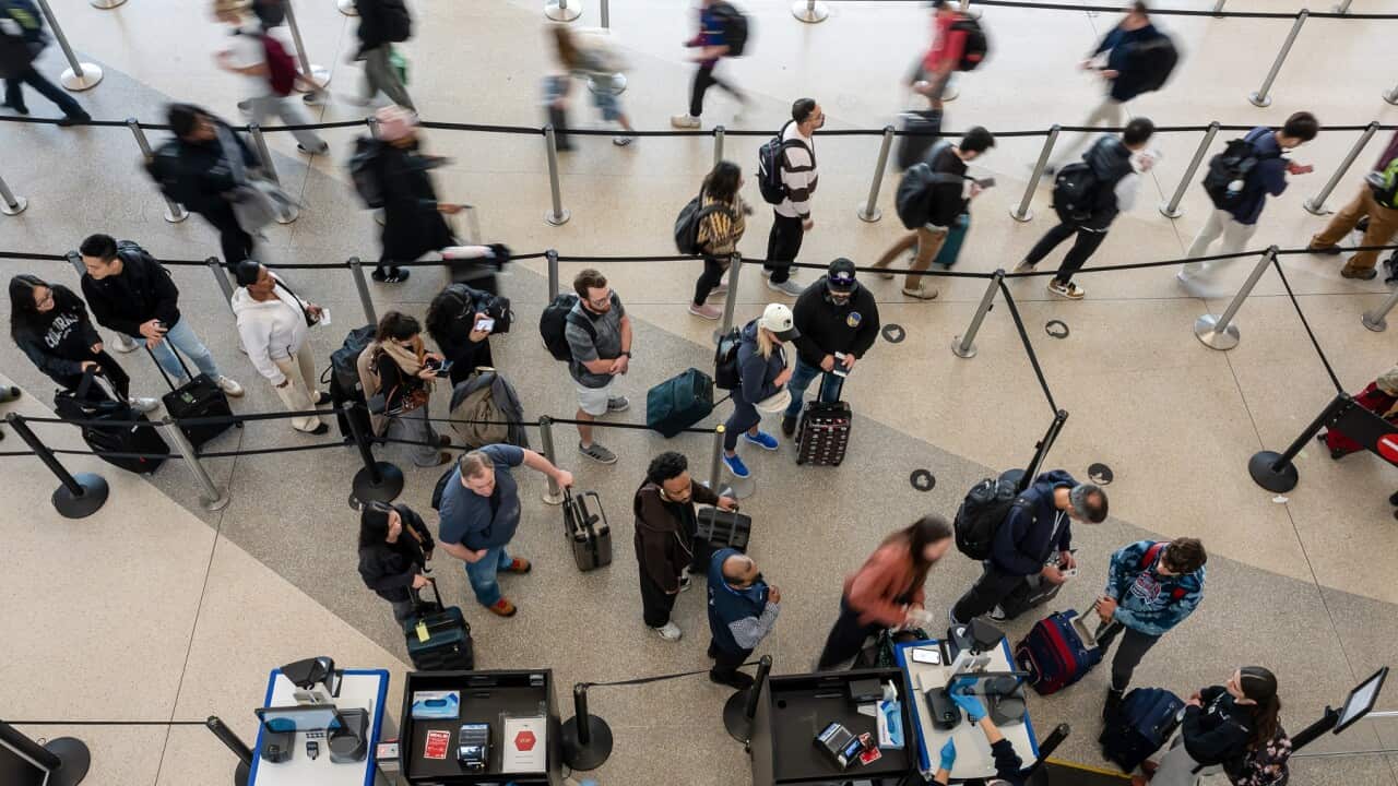 Travellers wait at a Transportation Security Administration checkpoint at San Francisco International Airport