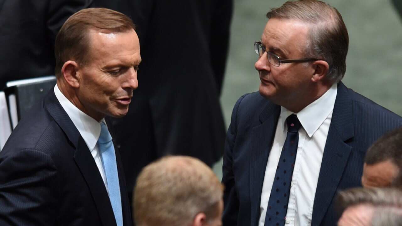 PM Tony Abbott (left) speaks to Labor MP Anthony Albanese