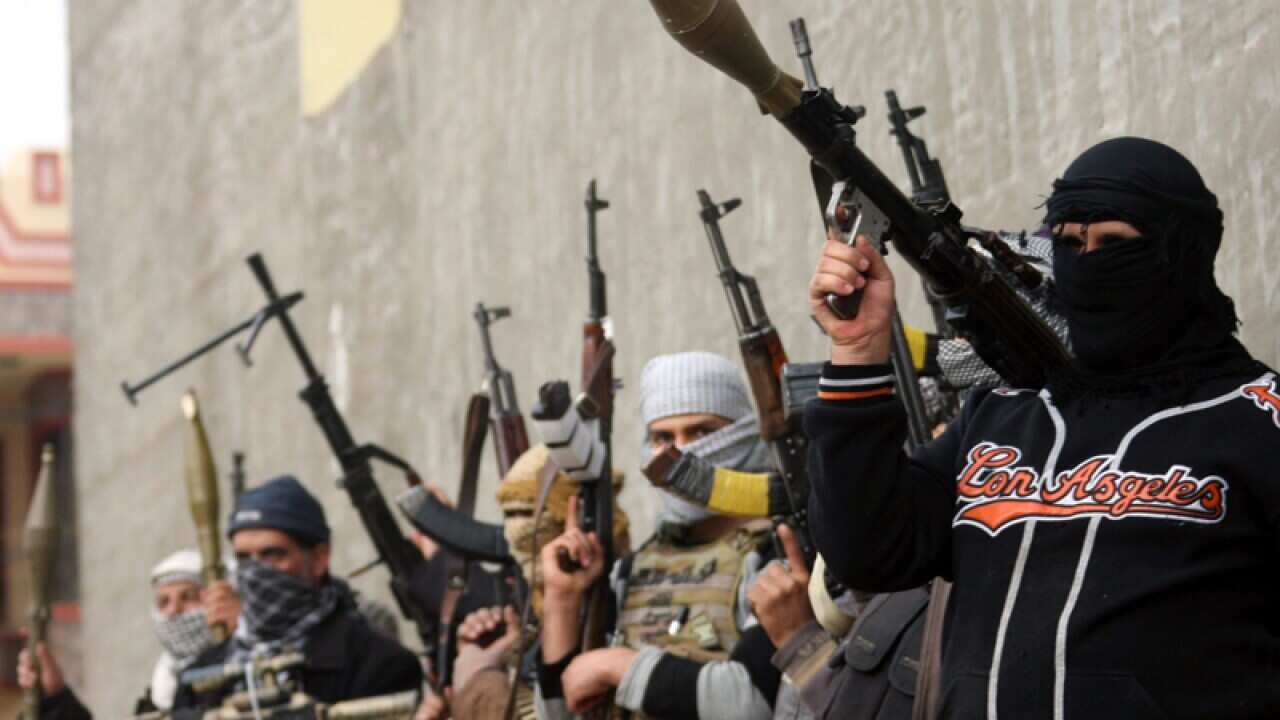 Sunni fighters carry RPG missiles launcher