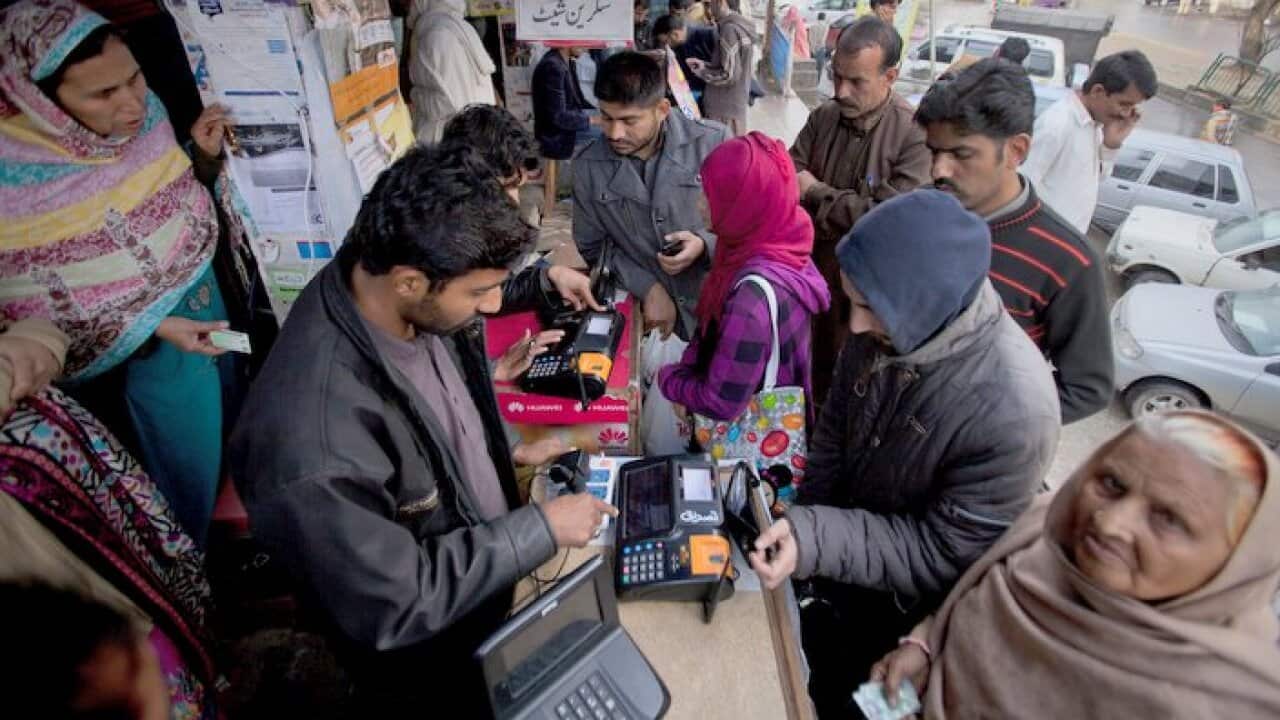 People lining up in Islamabad to give their  fingerprints and to get their phone SIM cards registered