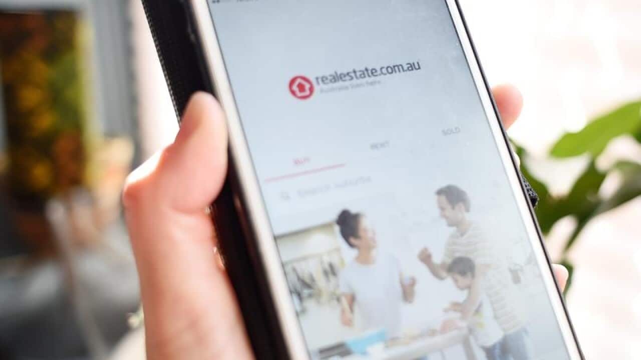 Realestate.com.au app shown on device.