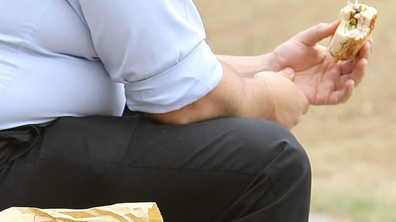 An overweight man eating