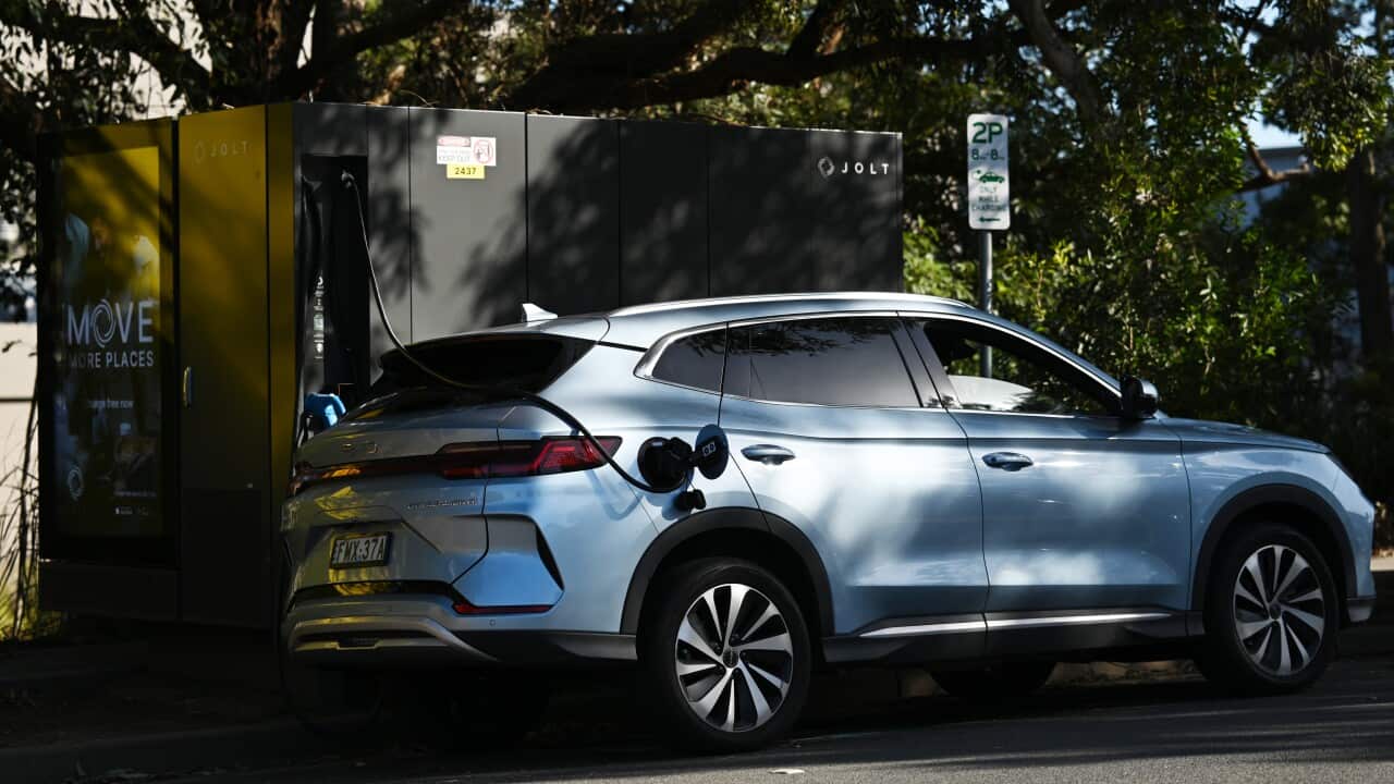 An electric vehicle parked and being charged.