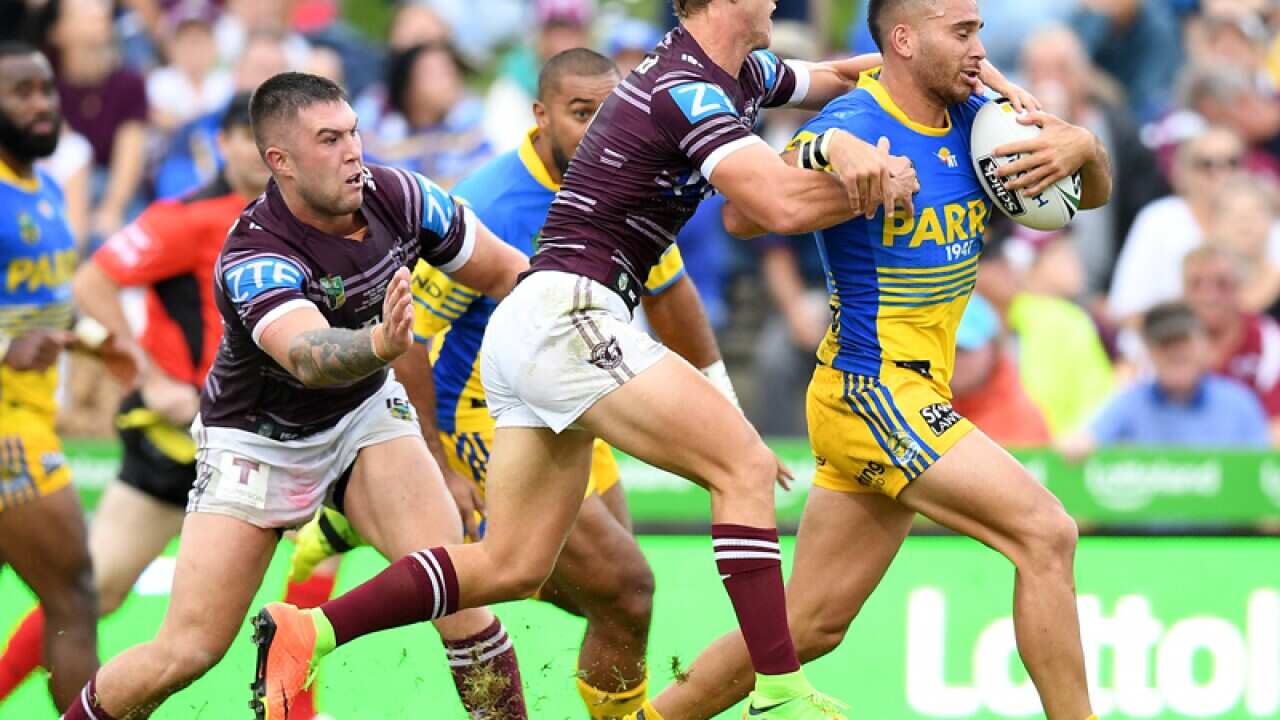Corey Norman of the Eels is tackled by Daly Cherry-Evans