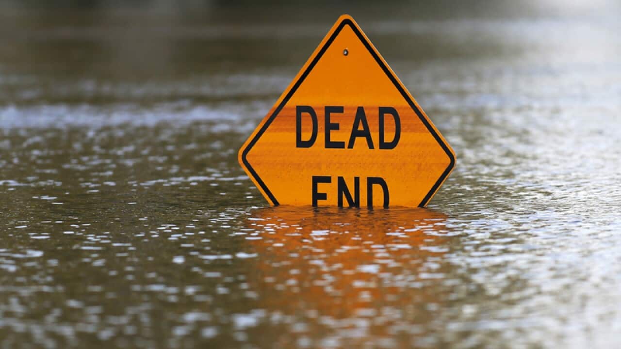A sign is partially submerged, caused by flooding