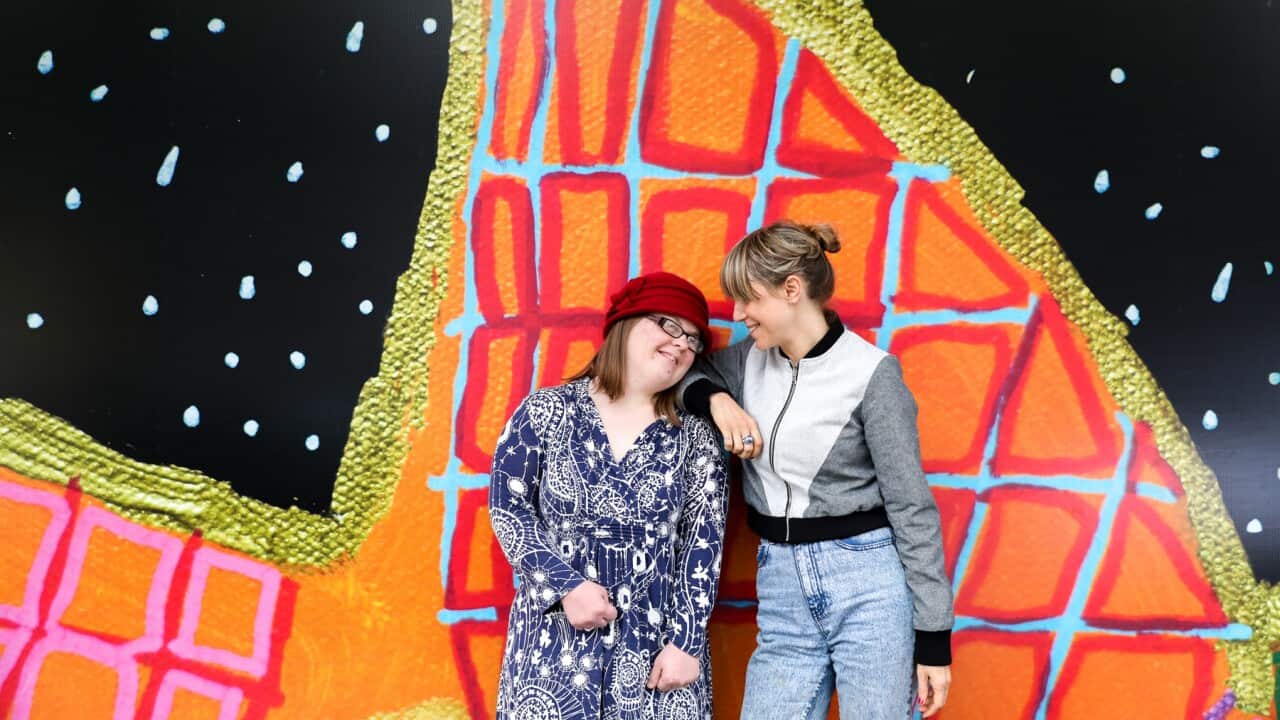 Studio A artist Emily Crockford (left) with artistic director Gabrielle Mordy in front of one of Emilys public murals in Sydney