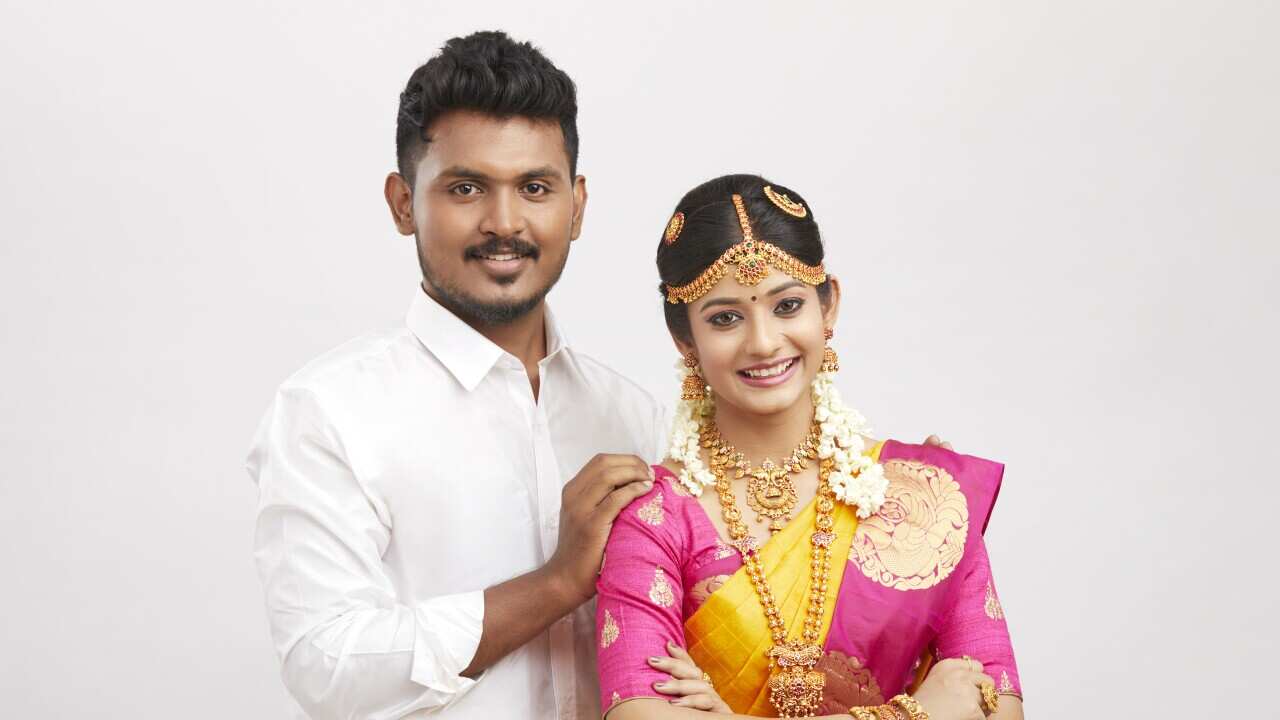 Attractive happy south Indian couple in traditional dress