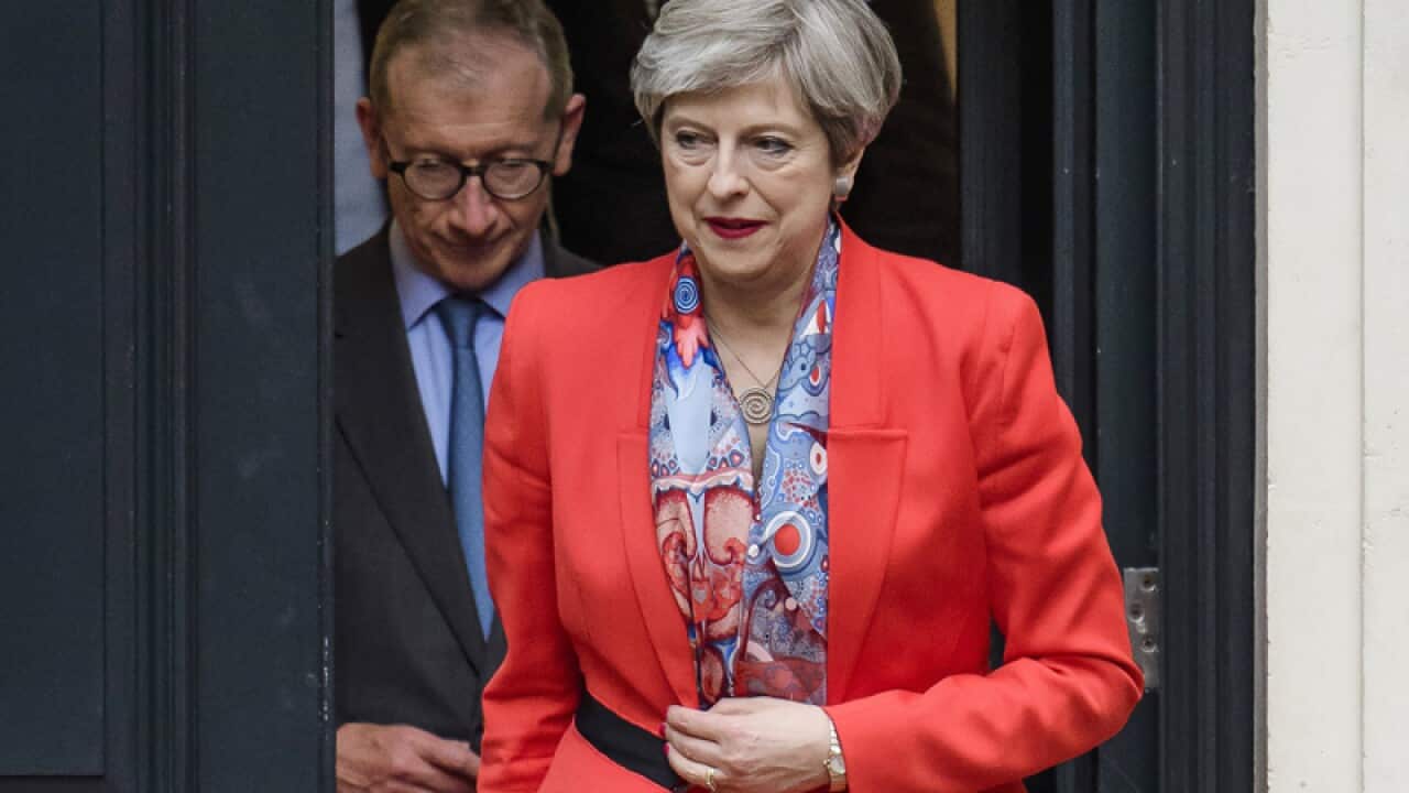British Prime Minister Theresa May (R) and her husband Philip
