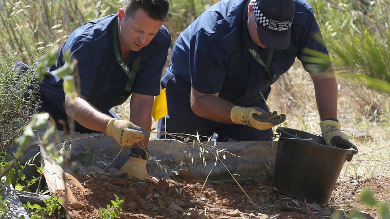 British police shift through soil