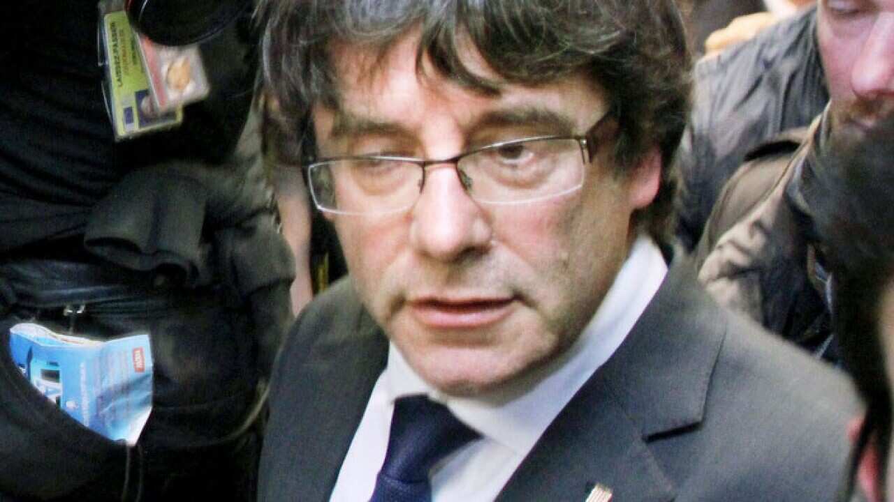 Ousted Catalan leader Carles Puigdemont leaves a press conference in Brussels