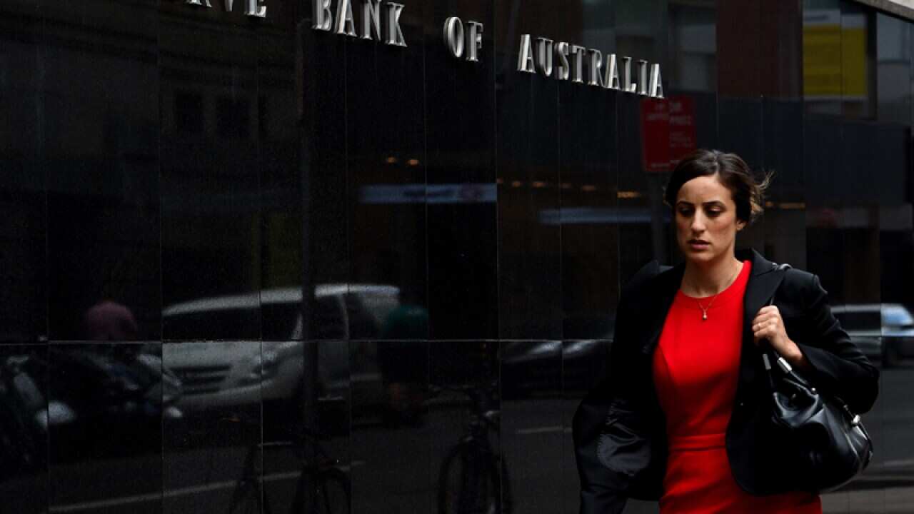 Pedestrians are seen walking past the Reserve Bank of Australia