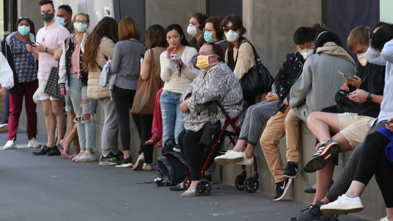 People line up outside the Royal Melbourne Hosital for coronavirus testing in Melbourne, Tuesday, March 10, 2020. (AAP Image/David Crosling) NO ARCHIVING