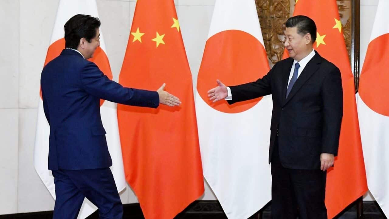 Chinese President Xi Jinping (R) greets Japanese Prime Minister Shinzo Abe prior to their talks in Beijing on Oct. 26, 2018. (Kyodo via AP Images) ==Kyodo
