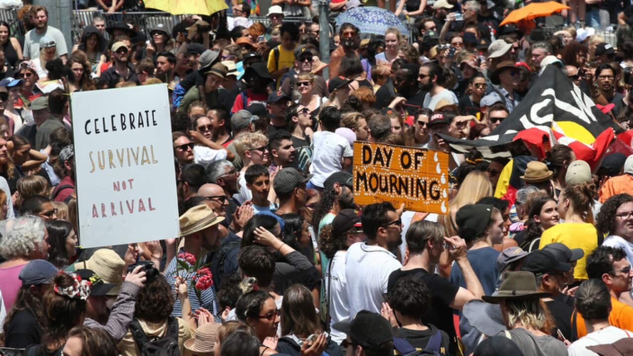 A large crowd of protesters take over the intersection in front of Flinders St Station as part of an 'Invasion Day' rally, Melbourne, Friday, January 26, 2018. (AAP Image/David Crosling) NO ARCHIVING