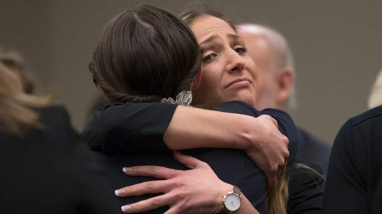 Kyle Stephens hugs Rachael Denhollander after giving her victim statement to the court sentencing Larry Nassar