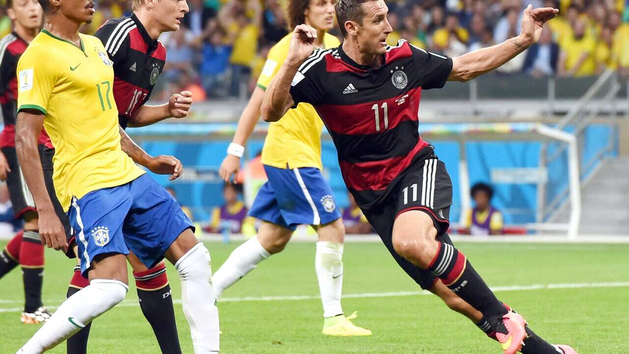 Germany's forward Miroslav Klose (R) scores the team's second goal in the first half of the semifinals of the match against Brazil (AP).