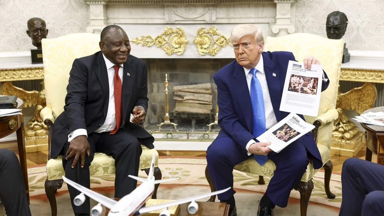 Donald Trump holds up news articles about violence in South Africa during a meeting with President Cyril Ramaphosa