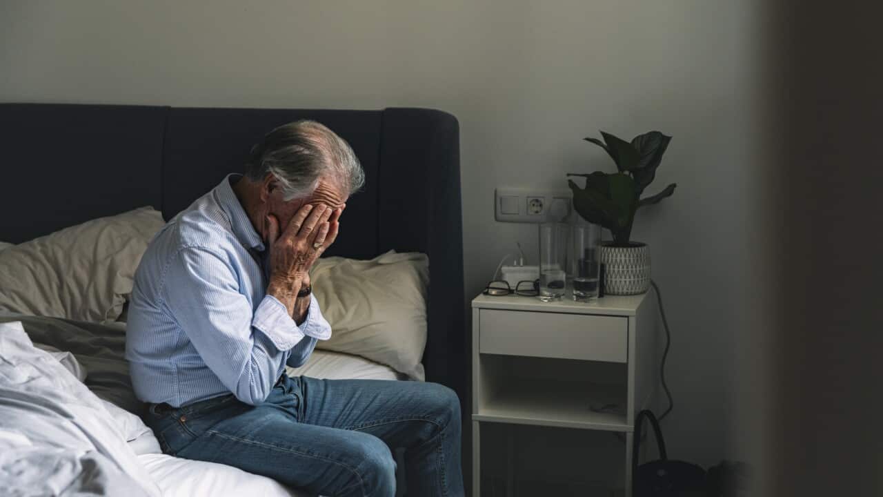 Senior male sitting on his bed - negative emotion