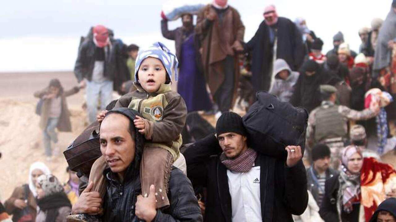 New arrivals of Syrian refugees cross the Jordan border with Syria.