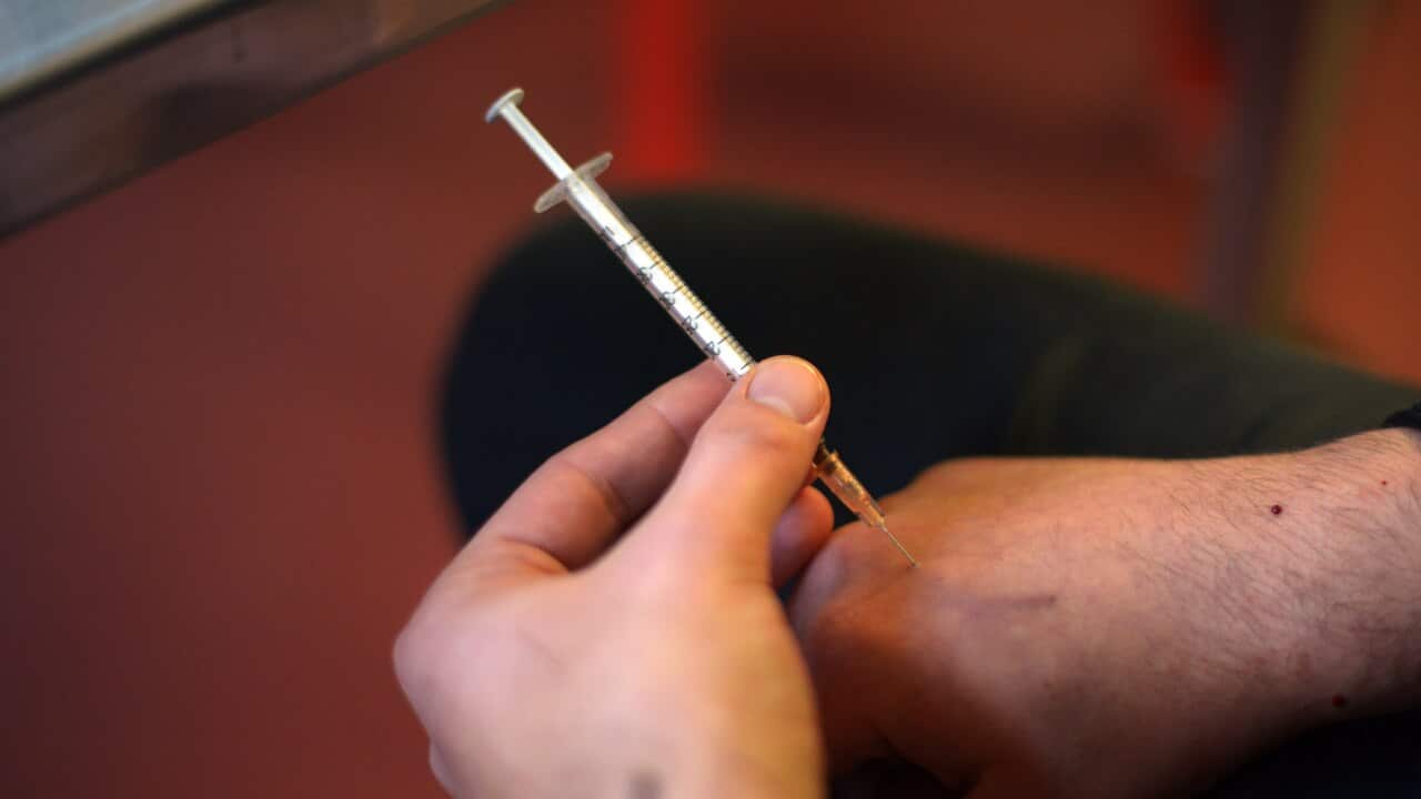 A user injects a heroin shot