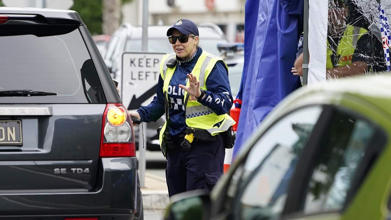 Police officer at a checkpoint on the Queensland-New South Wales border
