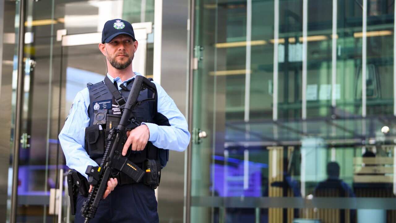 An Australian Federal Police (AFP) officer holds a Mk18 Short-Barrel Rifle