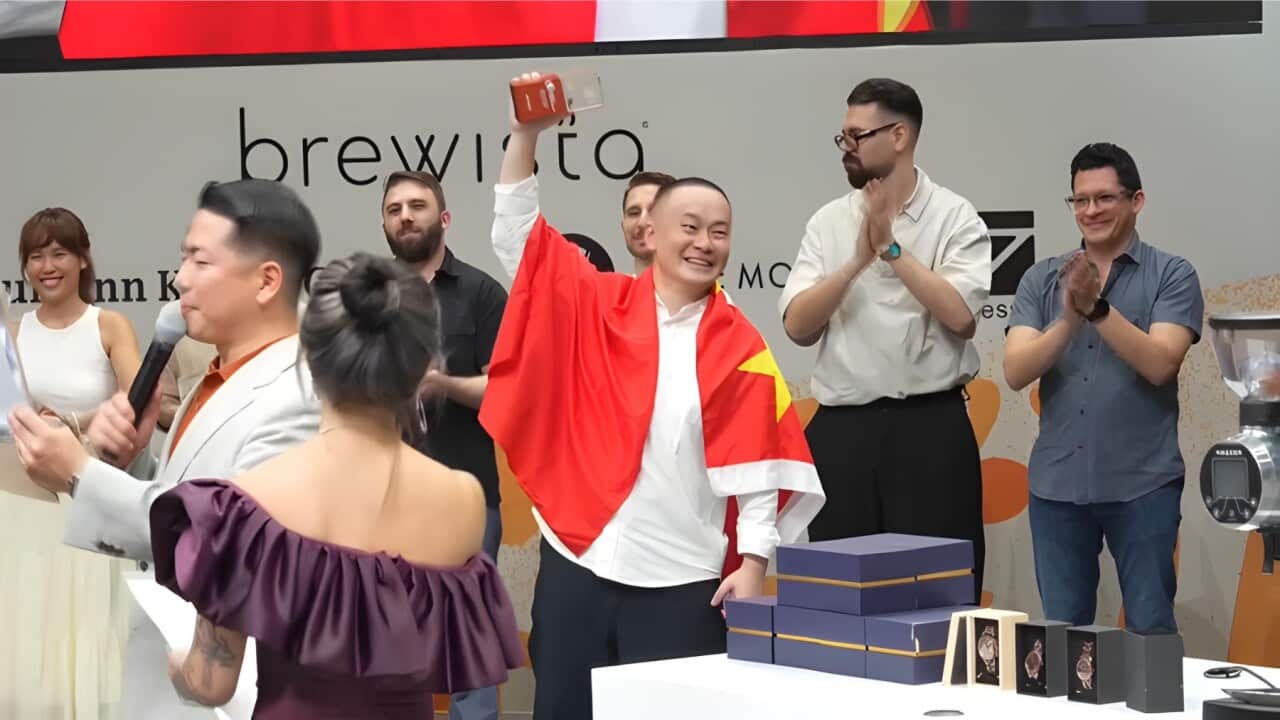 George Jinyang Peng of China holds up his World Champion Brewer trophy