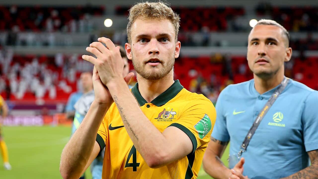 Nathaniel Atkinson applauds fans after a Socceroos match