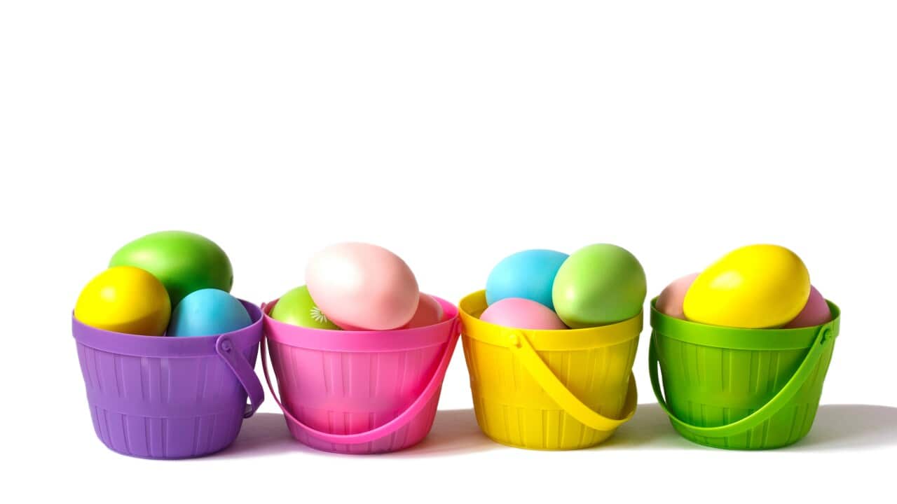Easter decoration eggs in colorful baskets on white background. copy space