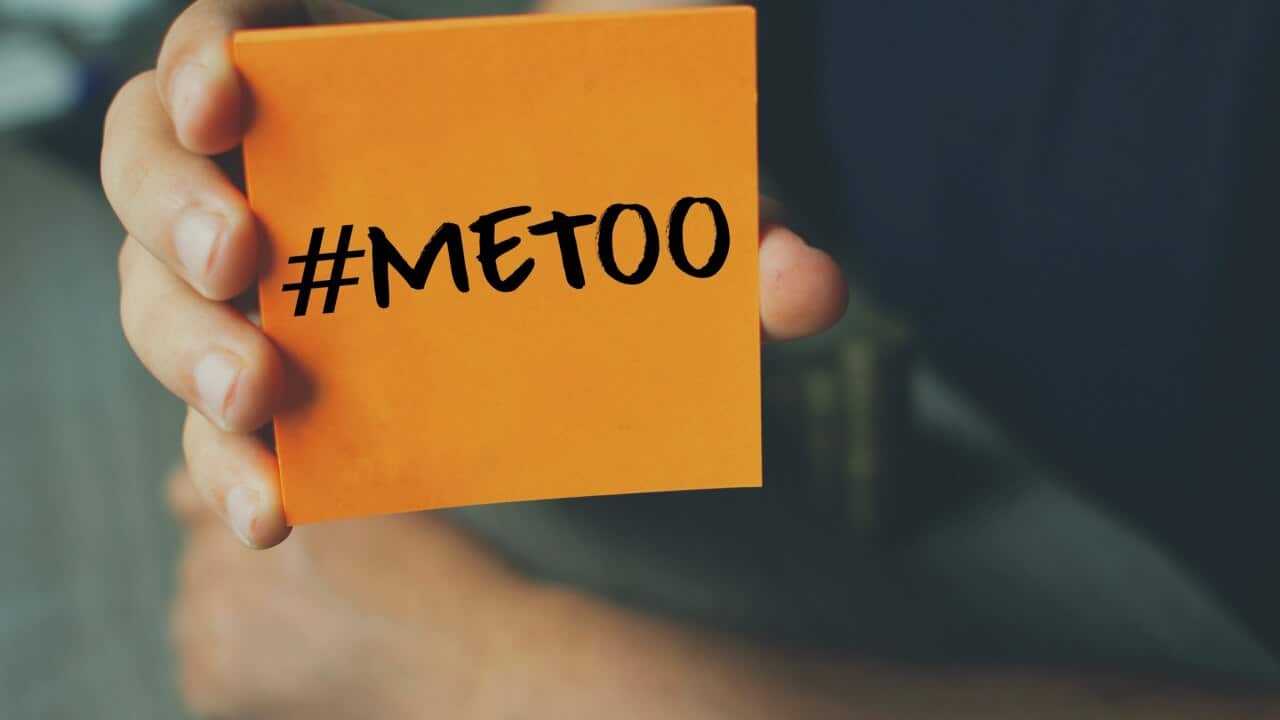 Me Too hashtag on orange note paper , anti sexual harassment social media campaign
