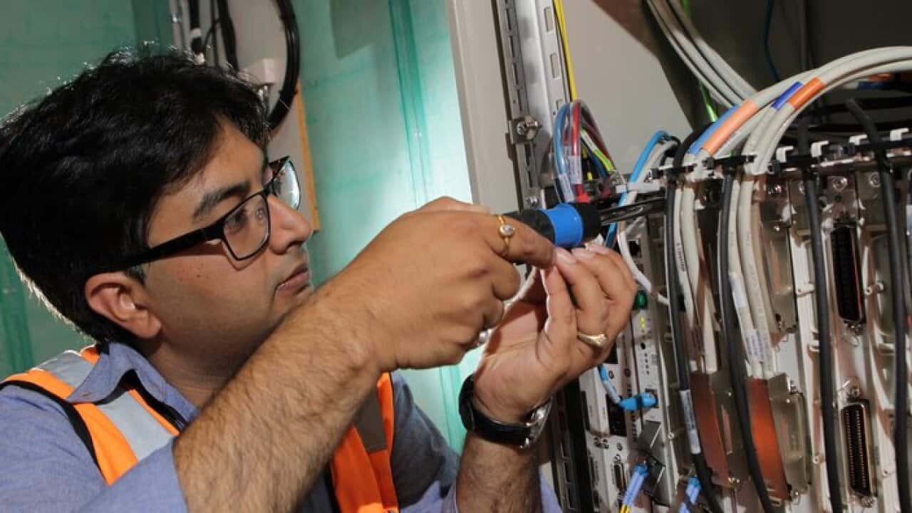 NBN technician Rajav Kapil connecting an apartment block to the National Broadband Network (NBN) in Brunswick, Melbourne,  Tuesday, March 11, 2014. (AAP Image/David Crosling) NO ARCHIVING