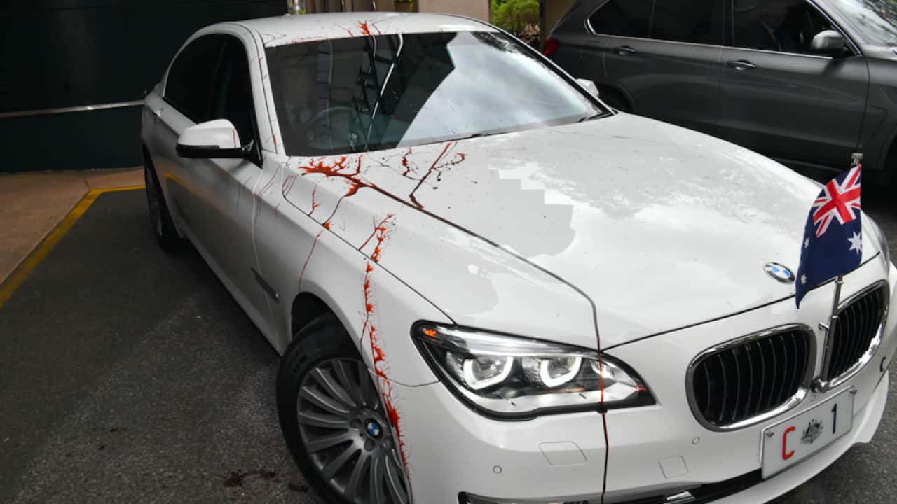 The Prime Minister's car is seen smeared in fake blood at the University of Queensland
