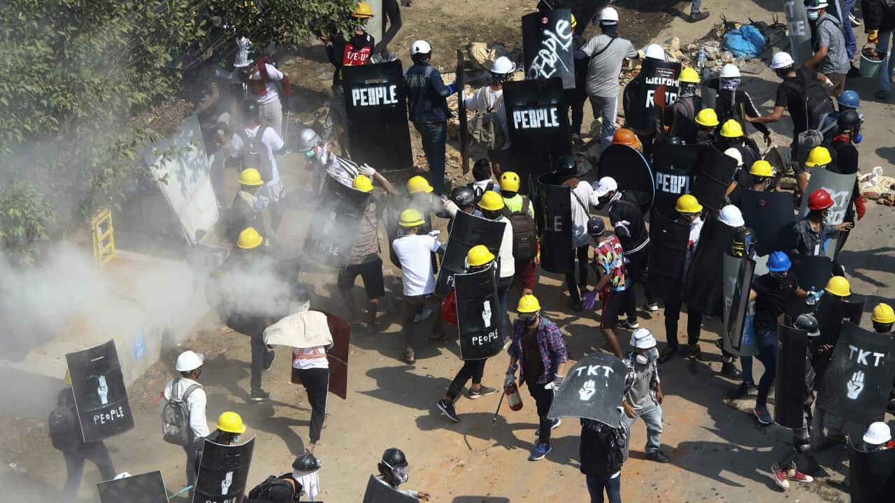Protesters disperse as Riot Police fire tear gas in Tharkata Township, outskirt of Yangon, Myanmar on 6 March 2021.  