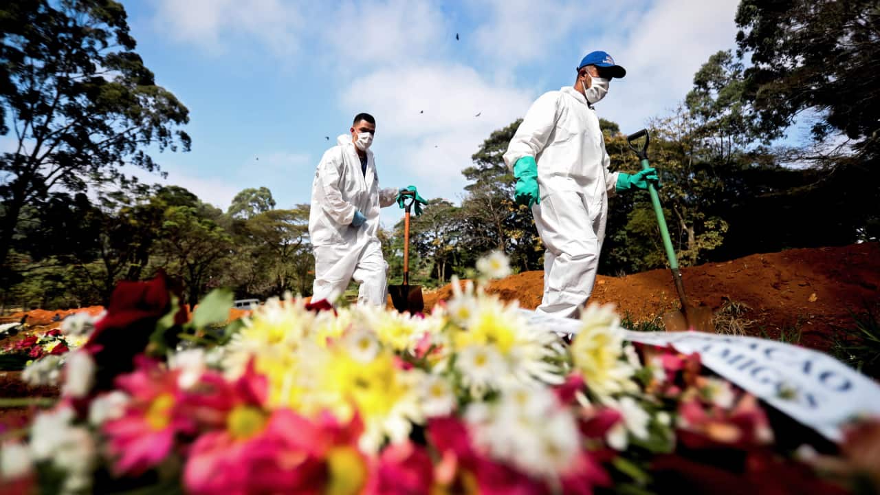 Gravediggers work in the Vila Formosa cemetery, in Sao Paulo, Brazil.