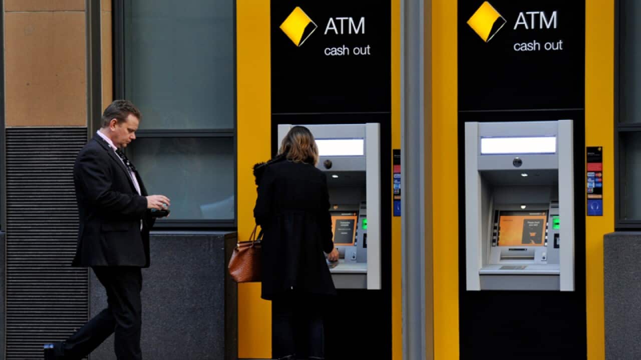 Customers use a Commonwealth Bank ATM